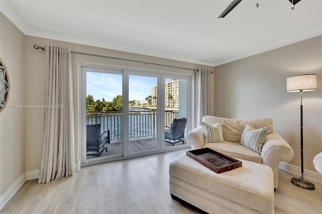 living area with light wood-style flooring and baseboards