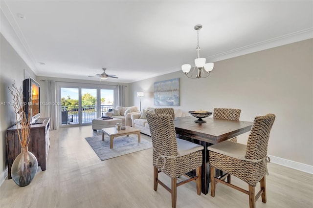 dining space with light wood-style floors, baseboards, ornamental molding, and ceiling fan with notable chandelier