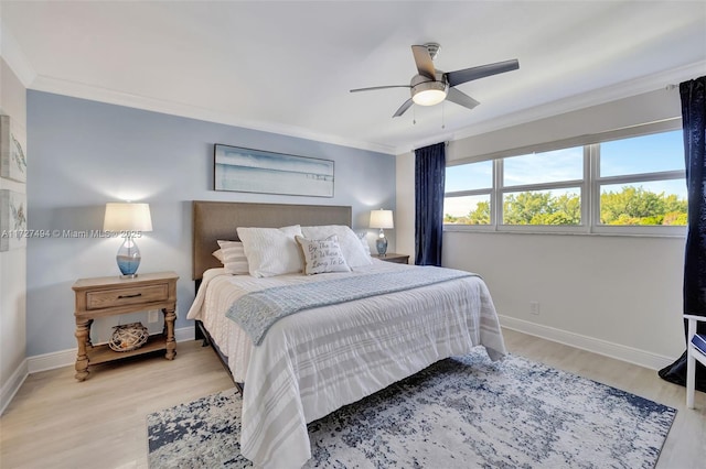 bedroom with baseboards, ornamental molding, and light wood-style floors