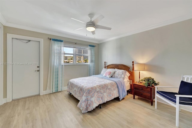 bedroom featuring baseboards, light wood-style flooring, ornamental molding, and a ceiling fan