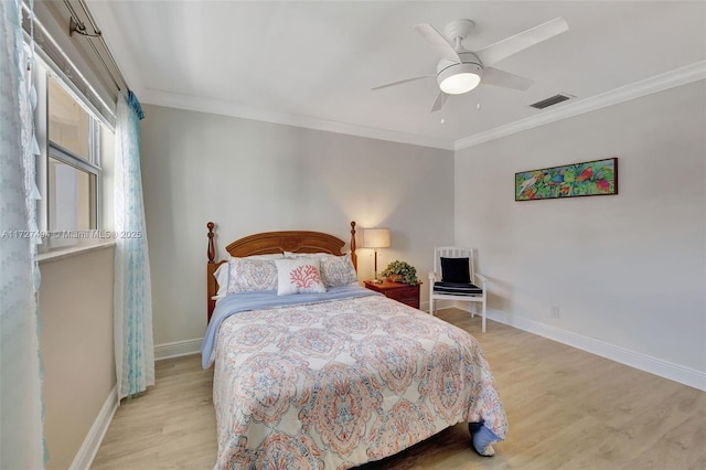 bedroom featuring ornamental molding, visible vents, and light wood finished floors