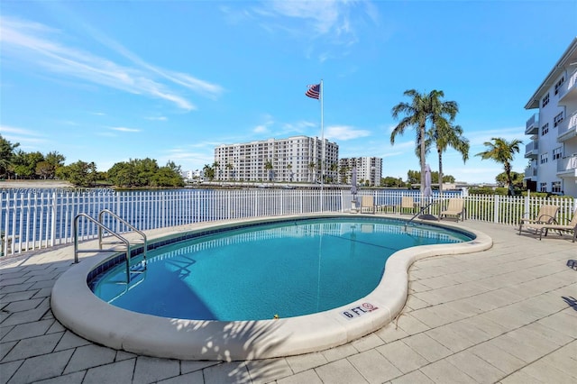 community pool with fence and a patio