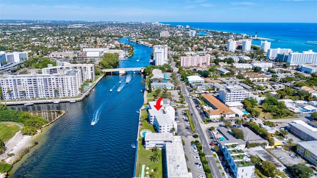 birds eye view of property featuring a view of city and a water view