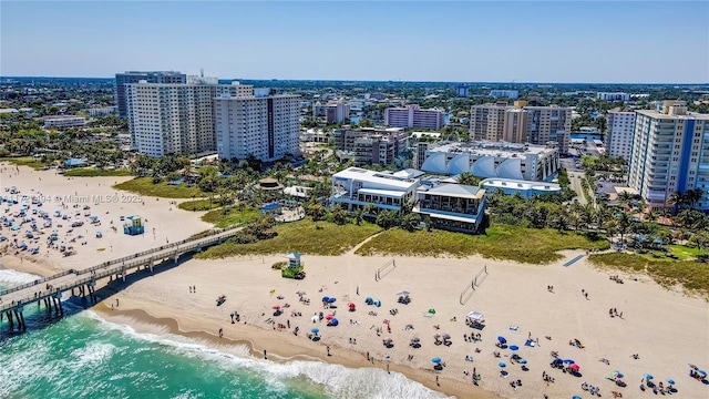 bird's eye view featuring a view of city, a water view, and a beach view