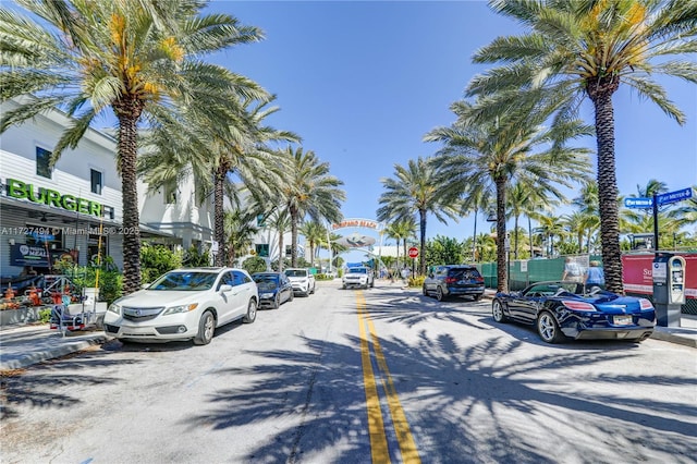 view of road with traffic signs, curbs, and sidewalks