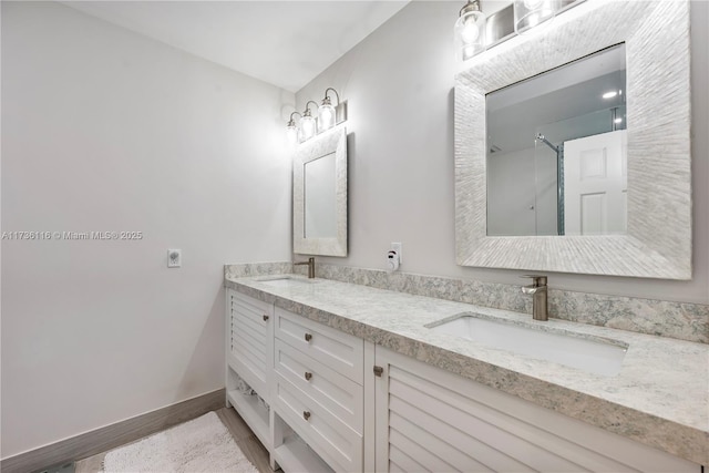 16141 W Troon Cir, Miami Lakes, FL 33014 - bathroom featuring double vanity, baseboards, and a shower