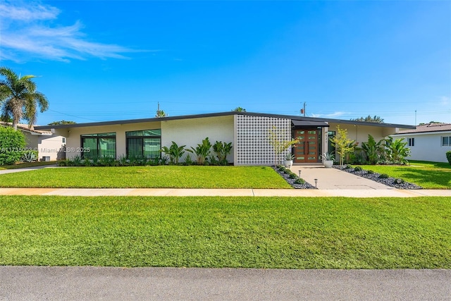 ranch-style home featuring french doors and a front yard