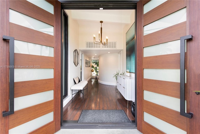 interior space with dark hardwood / wood-style flooring and an inviting chandelier