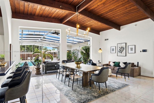 dining space with wood ceiling, a notable chandelier, light tile patterned flooring, and beamed ceiling