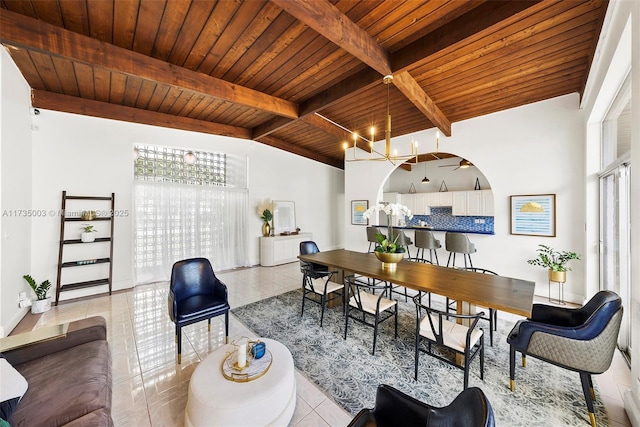 tiled dining room with vaulted ceiling with beams, wooden ceiling, and an inviting chandelier