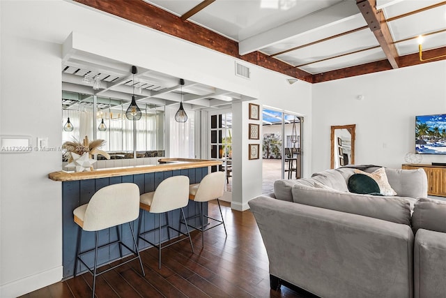 living room featuring dark wood-type flooring, indoor bar, coffered ceiling, and beam ceiling