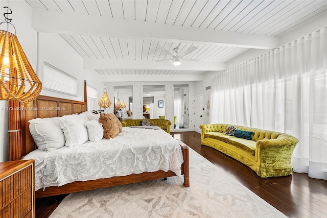 bedroom with beamed ceiling and wood-type flooring