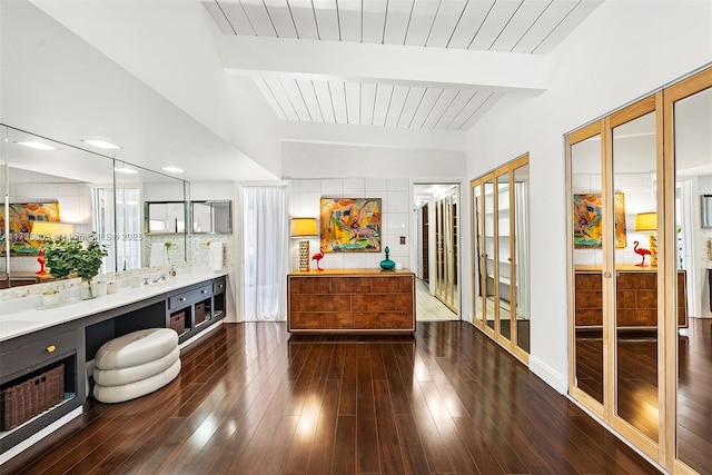 bathroom with hardwood / wood-style flooring, vanity, and beam ceiling