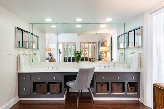 bathroom featuring vanity, hardwood / wood-style floors, and decorative backsplash