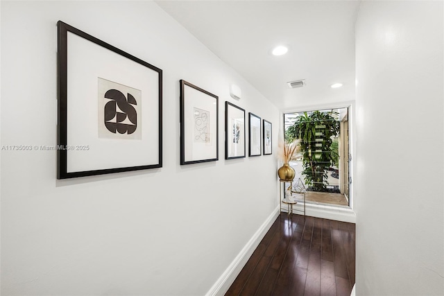 hallway with dark hardwood / wood-style flooring