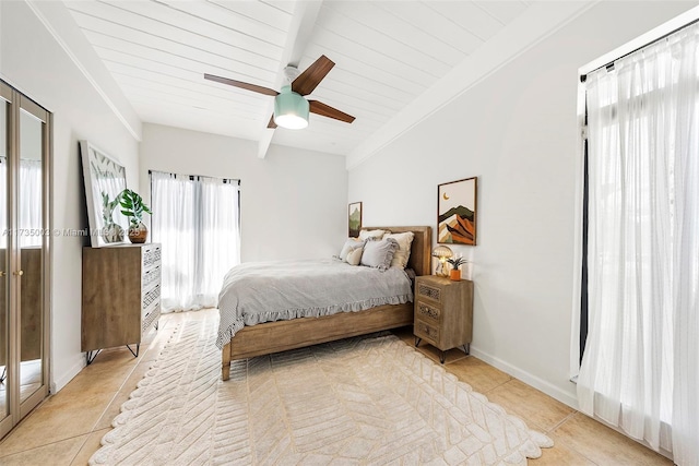 bedroom featuring light tile patterned floors, vaulted ceiling with beams, and ceiling fan