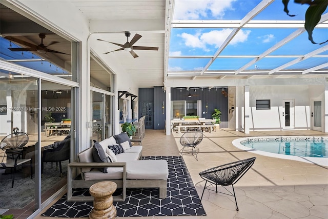 exterior space featuring ceiling fan, outdoor lounge area, and glass enclosure