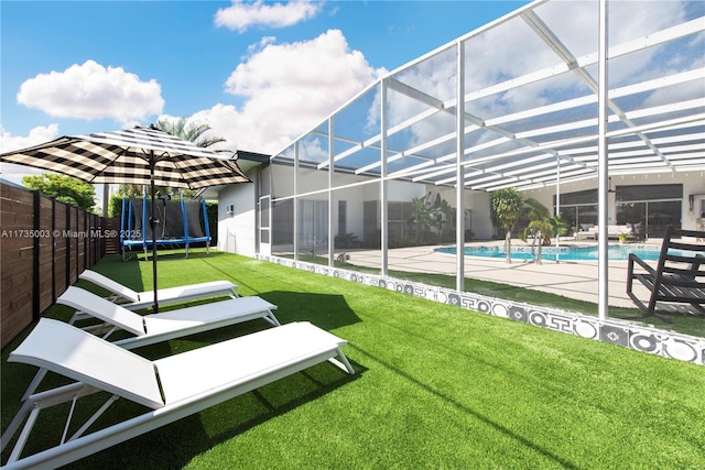 view of yard with a trampoline, a fenced in pool, a patio area, and glass enclosure