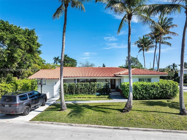 view of front of property with a garage and a front lawn