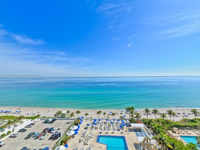 birds eye view of property with a beach view and a water view