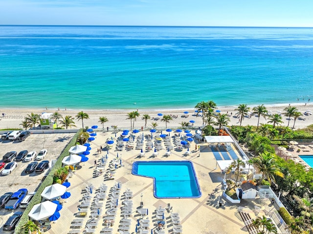 drone / aerial view with a beach view and a water view