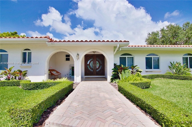 mediterranean / spanish-style home with a front yard