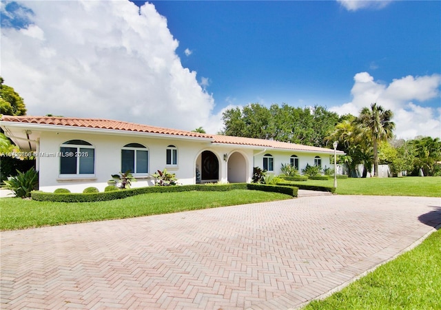 mediterranean / spanish house featuring a front yard