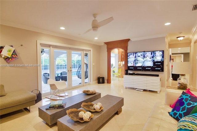 tiled living room with french doors, ceiling fan, and ornamental molding