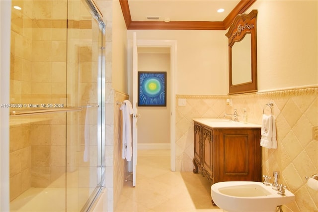 bathroom with crown molding, a bidet, tile walls, and vanity