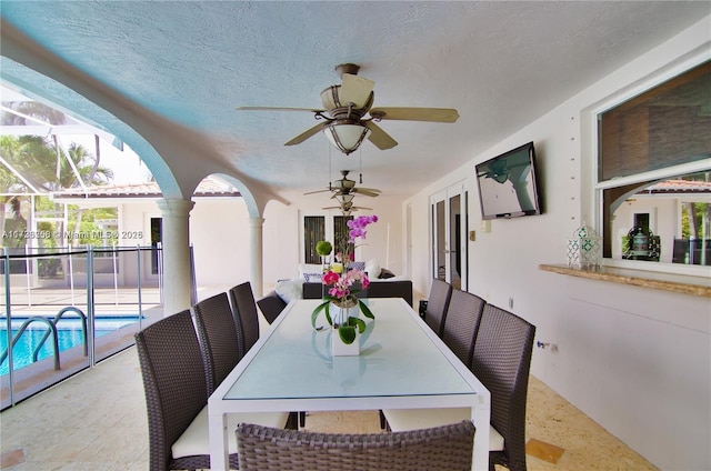 dining room with ceiling fan and a textured ceiling