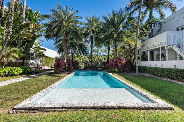 view of pool with a yard