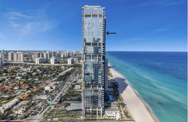 bird's eye view featuring a water view and a beach view