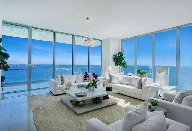 sunroom / solarium with a water view and a chandelier