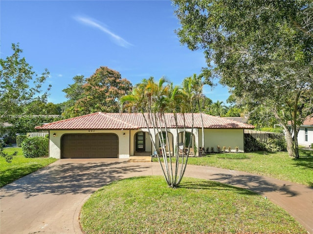 view of front of house featuring a garage and a front lawn