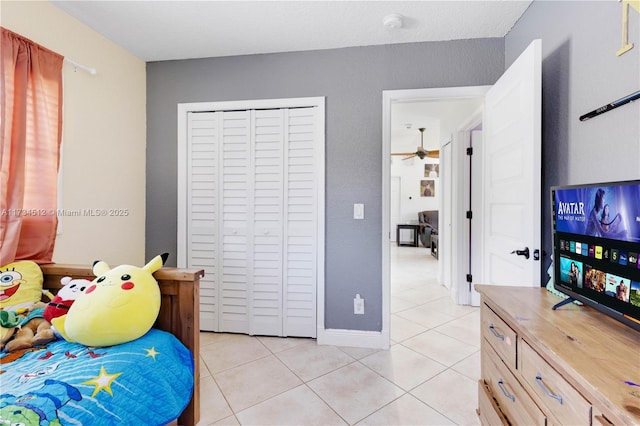 bedroom featuring light tile patterned floors and a closet