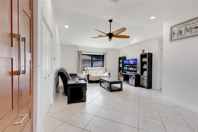 living room featuring vaulted ceiling, light tile patterned floors, and ceiling fan