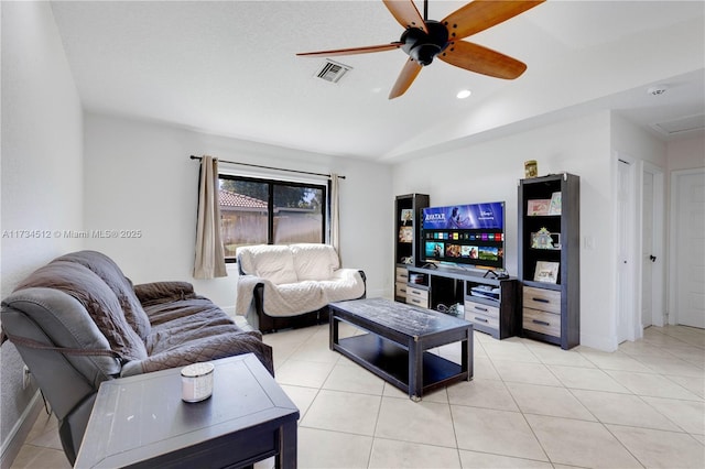 living room featuring vaulted ceiling, light tile patterned floors, and ceiling fan