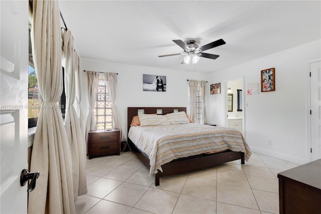 tiled bedroom featuring ceiling fan and connected bathroom