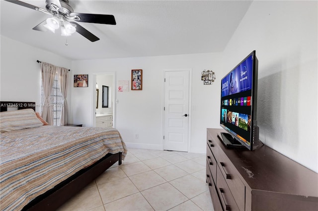 tiled bedroom featuring ceiling fan and ensuite bath