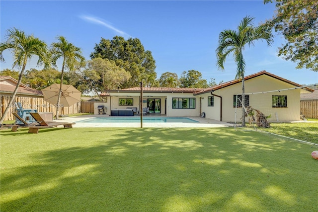 back of property featuring a patio and a yard