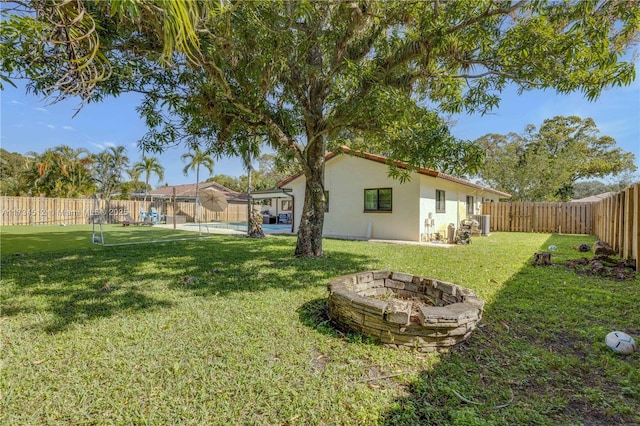 view of yard featuring an outdoor fire pit