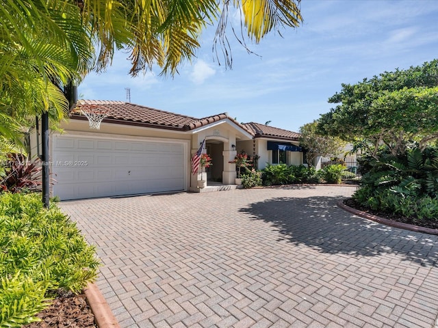 mediterranean / spanish-style home with a garage