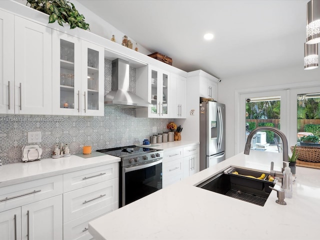 kitchen featuring stainless steel appliances, sink, white cabinets, and wall chimney exhaust hood