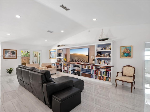 living room featuring vaulted ceiling and plenty of natural light