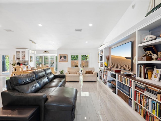 living room featuring lofted ceiling and light wood-type flooring