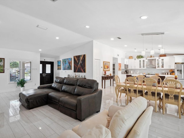 living room featuring vaulted ceiling