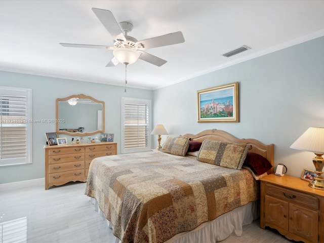 bedroom with ceiling fan and ornamental molding