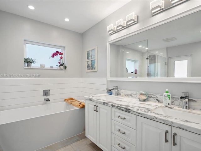 bathroom featuring vanity, shower with separate bathtub, and a healthy amount of sunlight