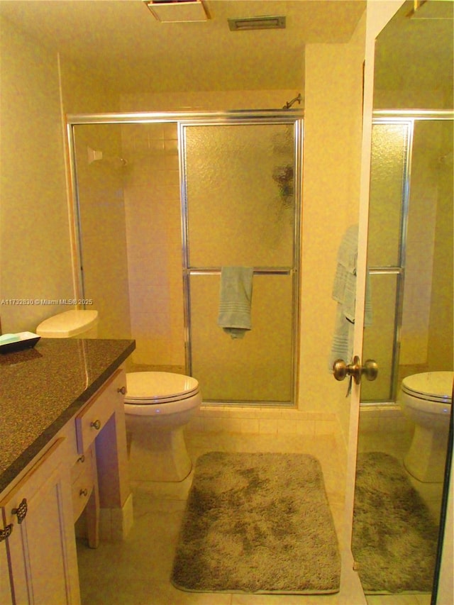 bathroom featuring vanity, tile patterned floors, and toilet