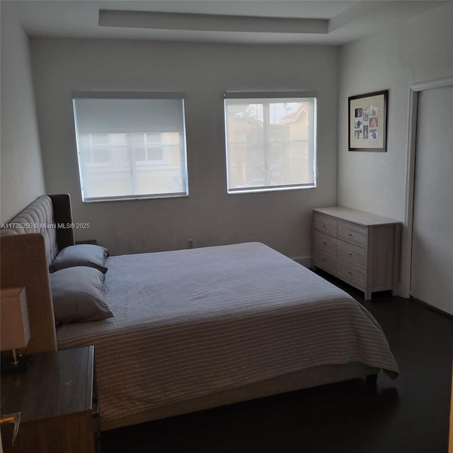 bedroom with dark wood-type flooring